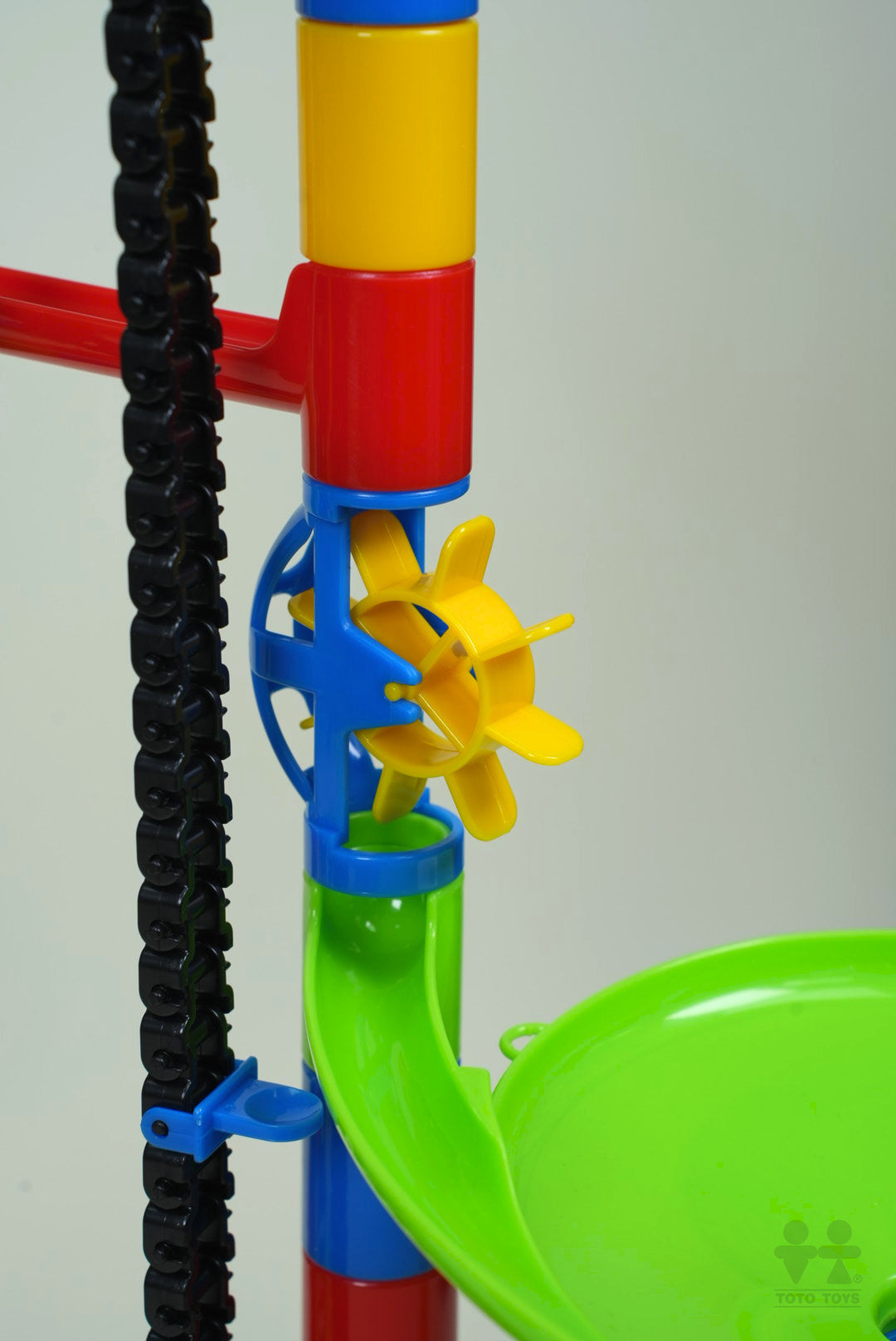 Close-up of the AutoRun waterwheel spinner, green funnel and striped supports with marbles