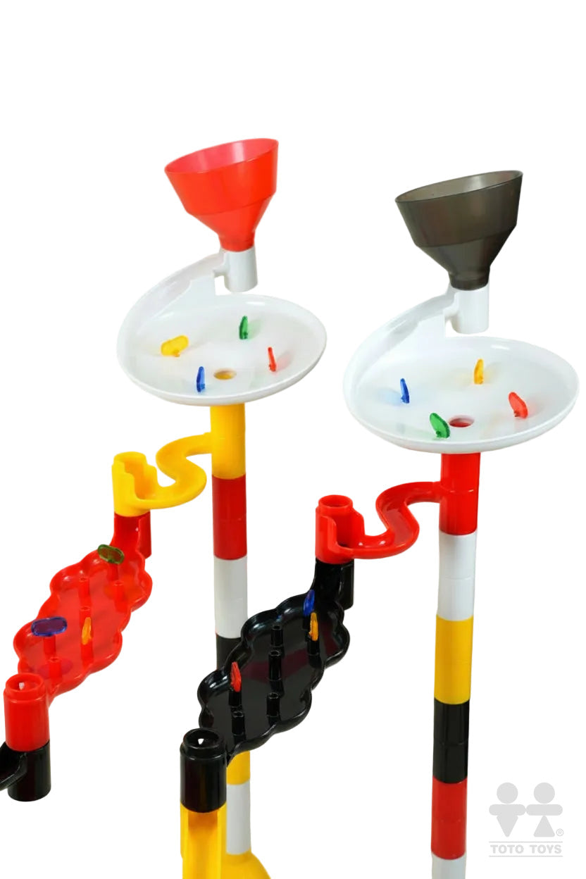 Close-up of the white funnel hoppers and yellow-and-red striped posts of the Marbulous racing set
