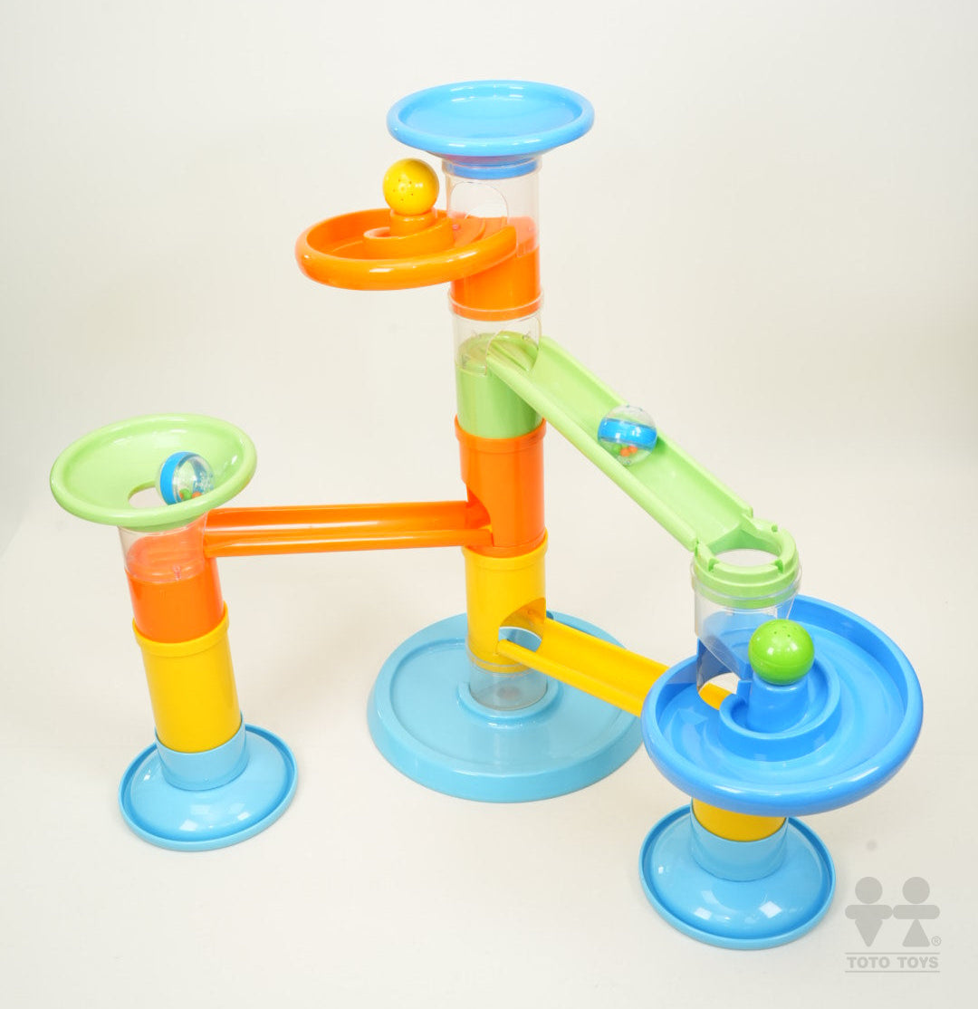 Rollipop Deluxe ball run studio shot with marbles travelling down the green ramp and blue dish